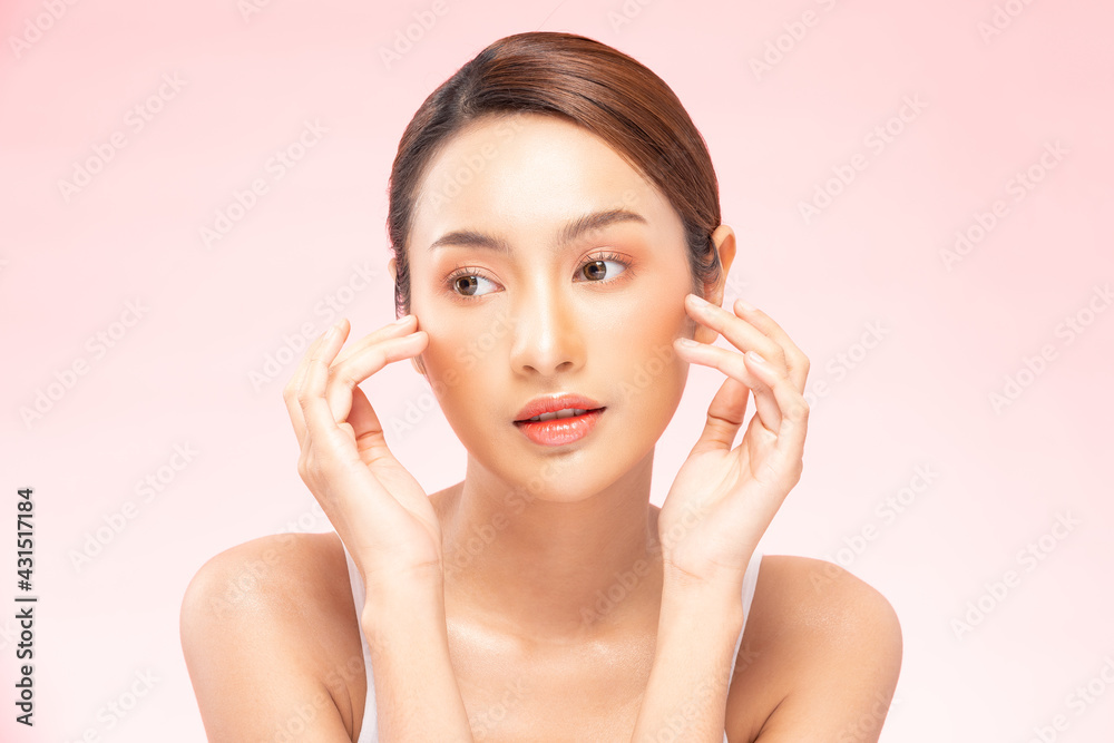 Wellness Asian young woman touch her cheek clean fresh and nutural pure skin,Pretty girl smile be moist skin on face shining like a model,Facial treatment of beauty woman,isolated on pink background Wellness Asian young woman touch her cheek clean fresh and nutural pure skin,Pretty girl smile be moist skin on face shining like a model,Facial treatment of beauty woman,isolated on pink background