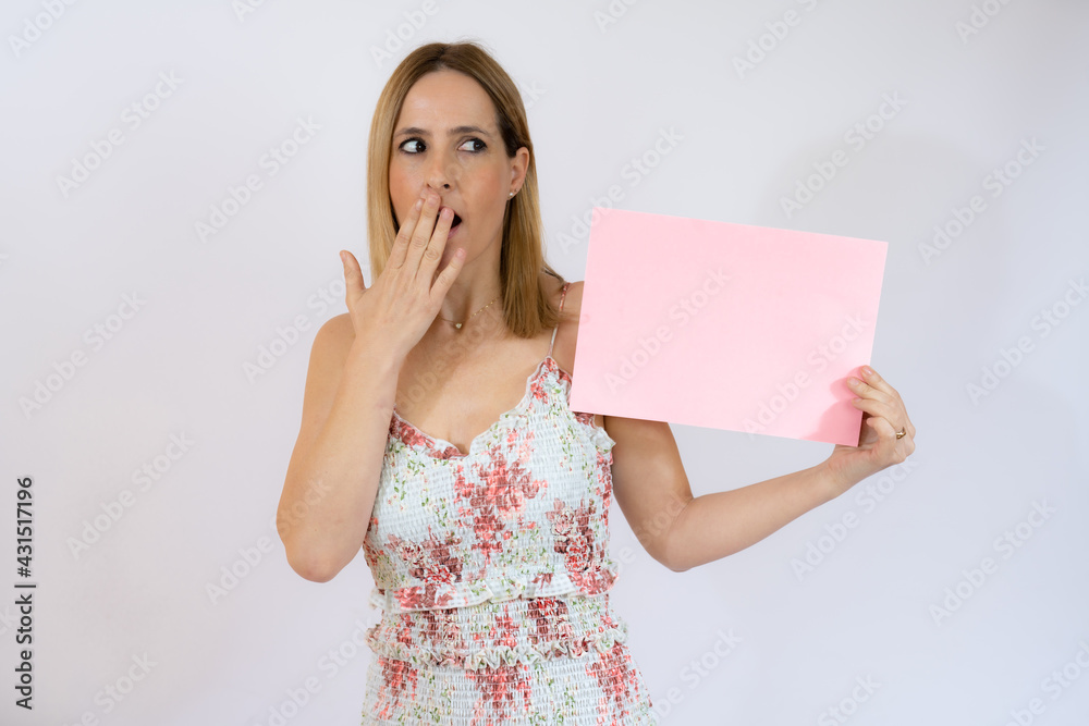 Young pretty woman cheerful and motivated, showing an empty poster where you can show a message, communication concept Young pretty woman cheerful and motivated, showing an empty poster where you can show a message, communication concept
