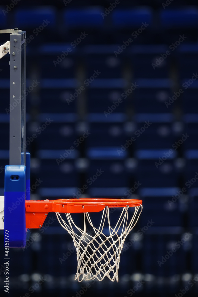 Basketball hoop on the background of the empty seats of the sports arena