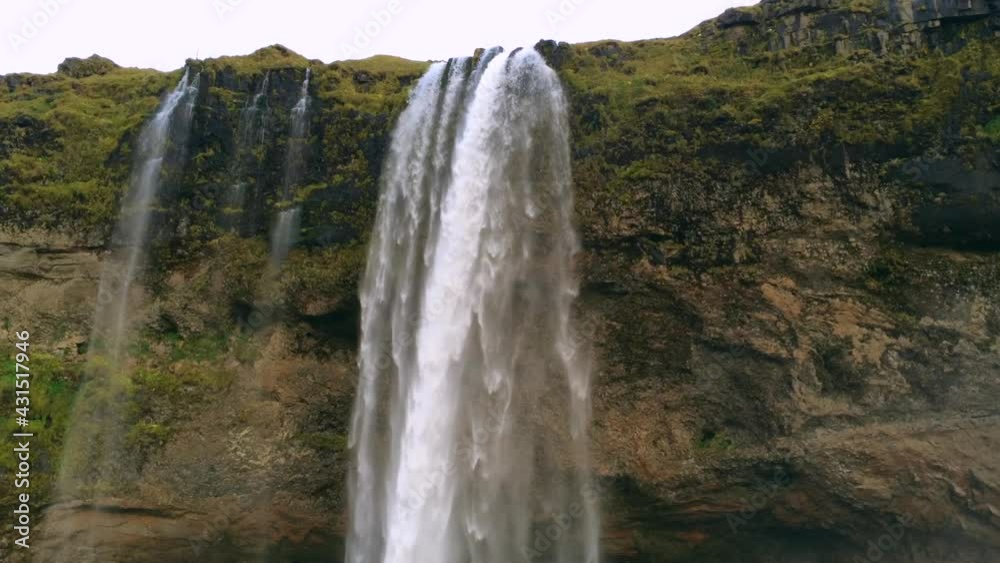 Iconic Seljalandsfoss Waterfall with Cave in Iceland. Breathtaking Waterfall. Iconic Seljalandsfoss Waterfall with Cave in Iceland. Breathtaking Waterfall.