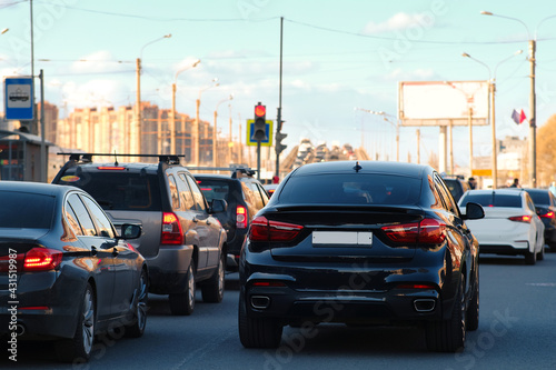 Background, blur, out of focus, bokeh. Traffic jams during rush hours after work. Red brake lights of stopped cars on the background of the city neighborhood. © Андрей Михайлов