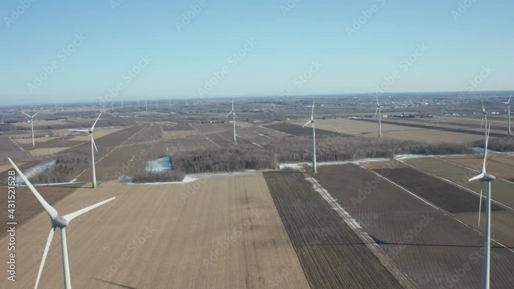 drone going back in a wind turbine field or wind farm in a sunny day, looking from high altitude in a sunny day drone going back in a wind turbine field or wind farm in a sunny day, looking from high altitude in a sunny day