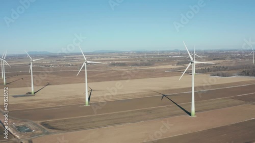 drone side move looking back of a wind turbines in a wind farm from right to left photo