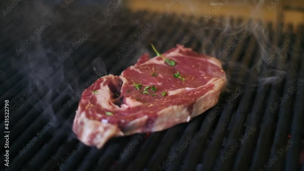 The steak is cooked on the grill. smoke comes out of the meat. 4K. The steak is cooked on the grill. smoke comes out of the meat. 4K.