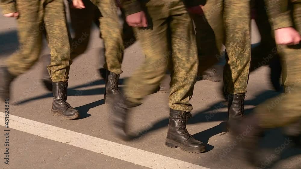 parade of military women and men legs in the frame marching