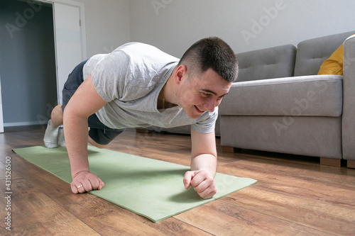 Get Fit At Home. Young active man training, exercising, stretching during morning workout at home. Sport, healthy lifestyle. Web Banner