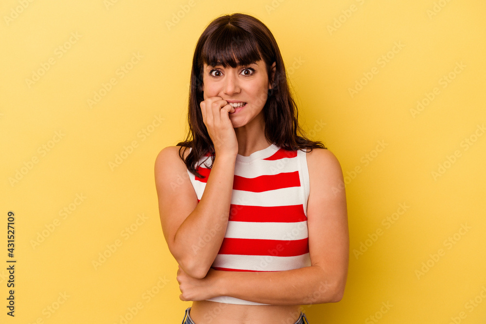 Young caucasian woman isolated on yellow background biting fingernails, nervous and very anxious. Young caucasian woman isolated on yellow background biting fingernails, nervous and very anxious.