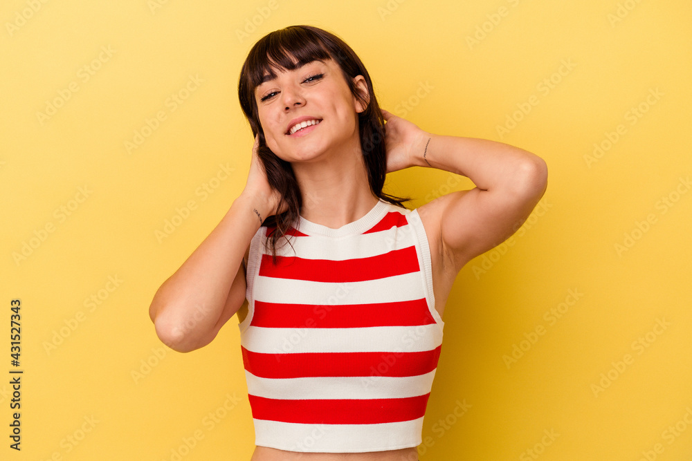 Young caucasian woman isolated on yellow background stretching arms, relaxed position. Young caucasian woman isolated on yellow background stretching arms, relaxed position.