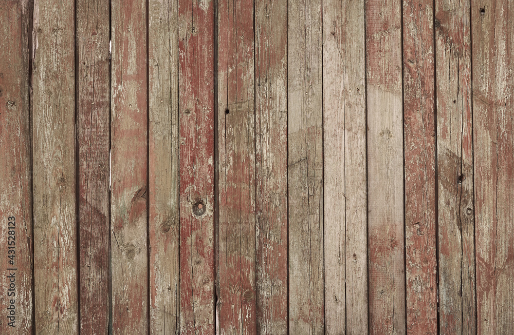 Red coated wood background. Cracked paint. Aged plank wood. Vertical boards covered with cracked paint Red coated wood background. Cracked paint. Aged plank wood. Vertical boards covered with cracked paint