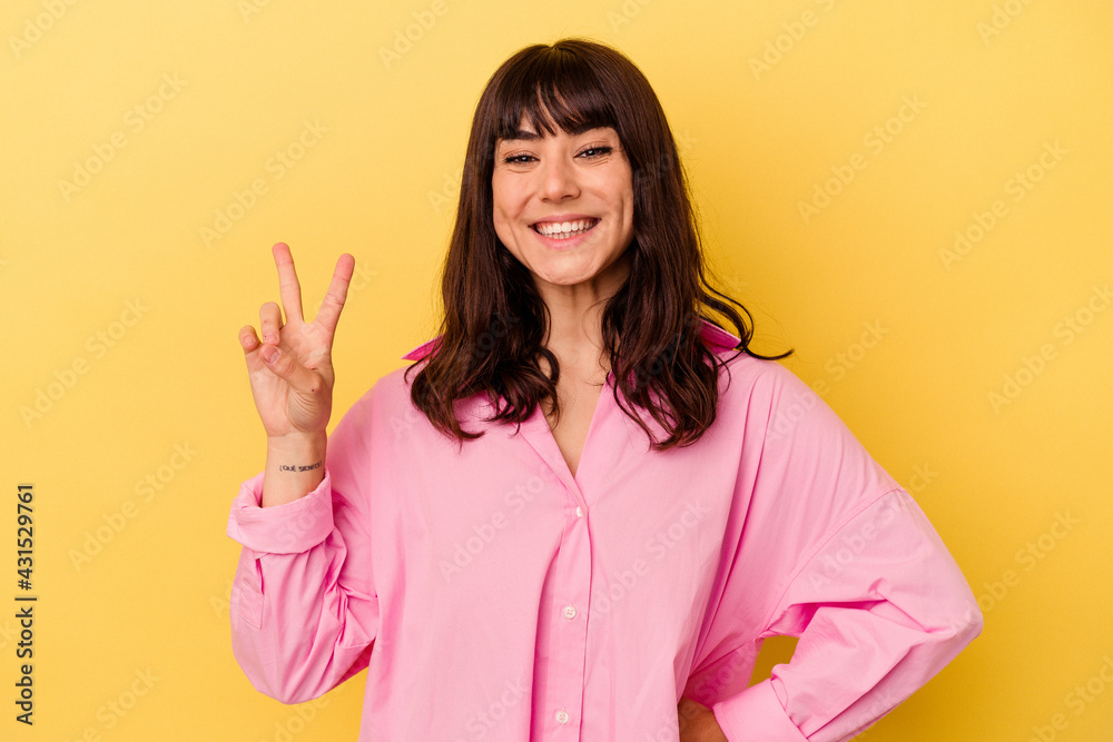 Young caucasian woman isolated on yellow background showing number two with fingers. Young caucasian woman isolated on yellow background showing number two with fingers.