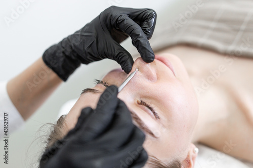 Girl in a beauty salon cleaning the pores on her face