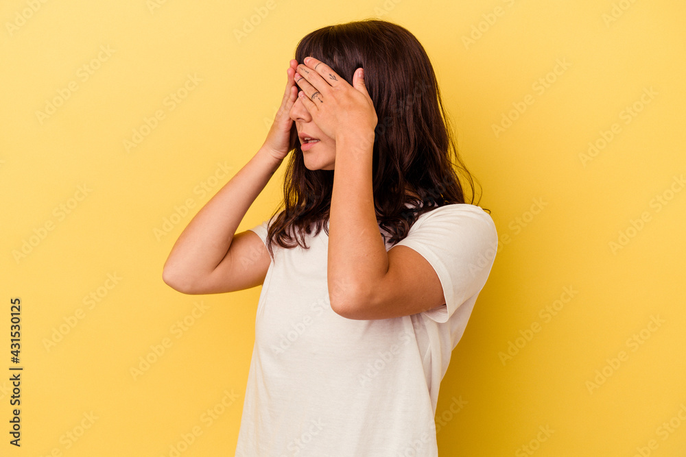 Young caucasian woman isolated on yellow background afraid covering eyes with hands. Young caucasian woman isolated on yellow background afraid covering eyes with hands.