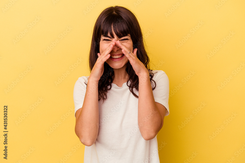 Young caucasian woman isolated on yellow background saying a gossip, pointing to side reporting something. Young caucasian woman isolated on yellow background saying a gossip, pointing to side reporting something.
