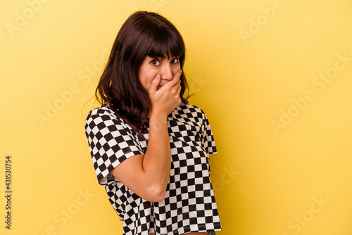 Young caucasian woman isolated on yellow background scared and afraid.