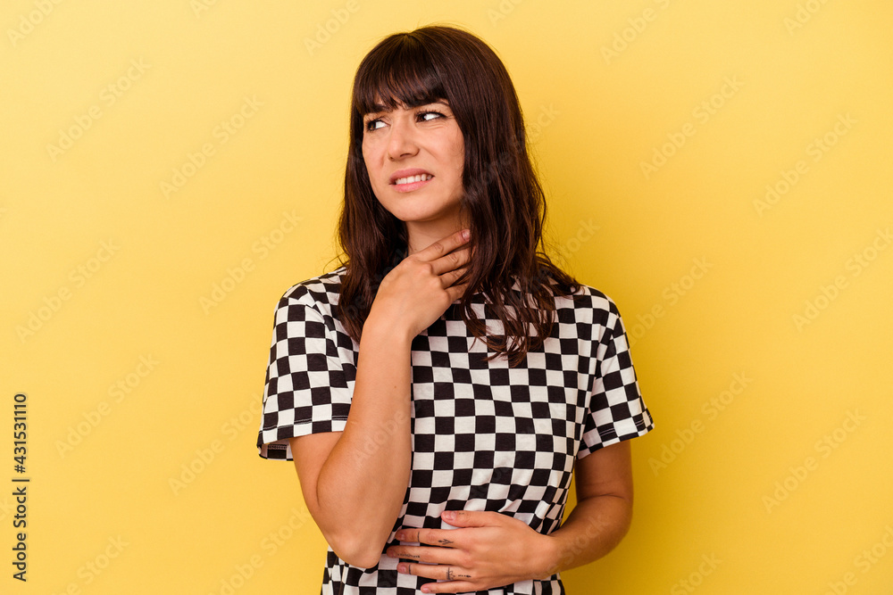 Young caucasian woman isolated on yellow background suffers pain in throat due a virus or infection. Young caucasian woman isolated on yellow background suffers pain in throat due a virus or infection.