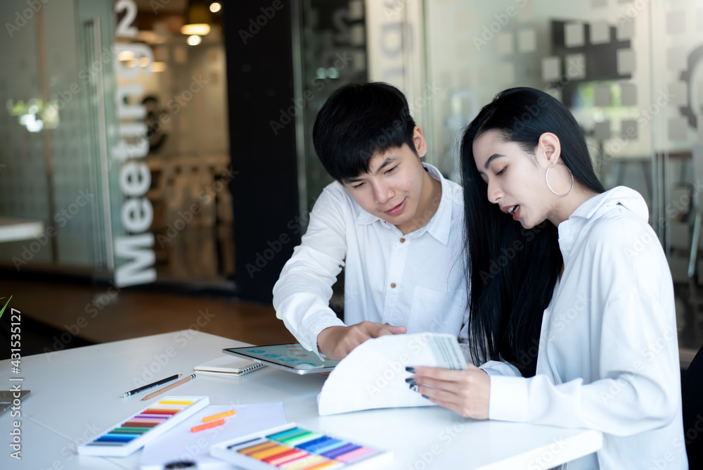 Asian designers man are sharing ideas with customer for the interior using a tablet at the office. Asian designers man are sharing ideas with customer for the interior using a tablet at the office.