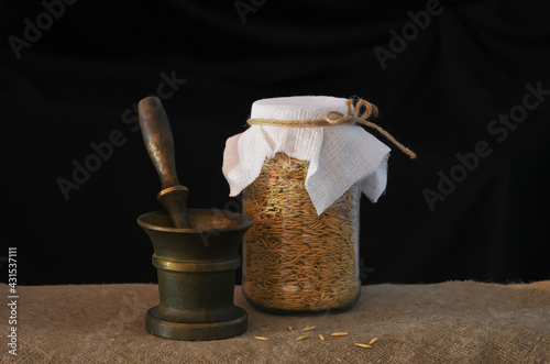 Still life with a mortar,  grains and a can