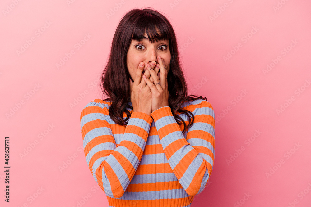 Young caucasian woman isolated on pink background shocked, covering mouth with hands, anxious to discover something new. Young caucasian woman isolated on pink background shocked, covering mouth with hands, anxious to discover something new.