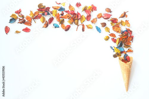 Top view of ice cream cone with colorful flower on the white background 