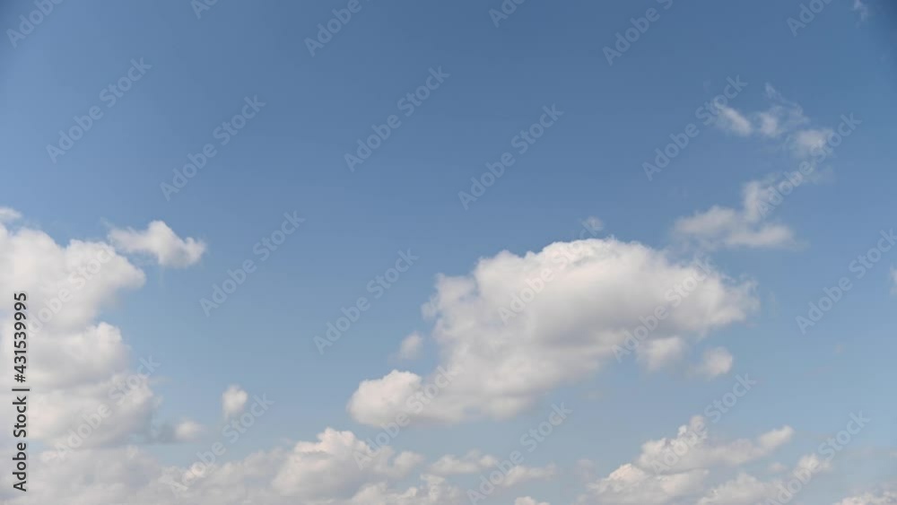 Timelapse sky fluffy white clouds. slow moving clouds on a blue background. Video Background of the movement of air masses across the sky. Universal b-roll Timelapse sky fluffy white clouds. slow moving clouds on a blue background. Video Background of the movement of air masses across the sky. Universal b-roll
