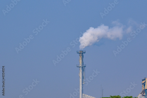 Smoke from factory chimneys. Emissions of air pollution and cause global warming.