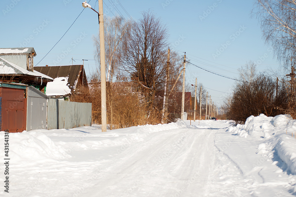 Village street covered with white snow.