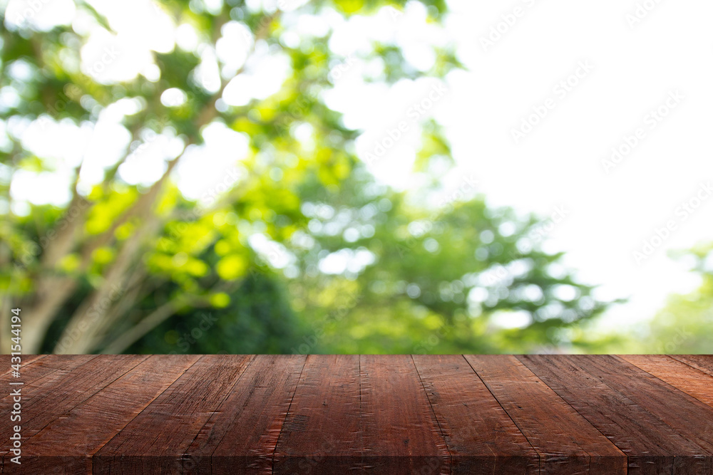 Wood floor with blurred trees of nature park background and summer season, product display montage Wood floor with blurred trees of nature park background and summer season, product display montage