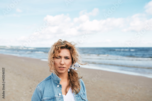 ,BEAUTIFUL NATURAL BLOND GIRL BY THE SEA, BOKEH PORTRAIT, SUNSET ON THE BEACH, denim jacket