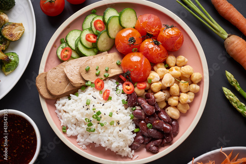 Healthy Organic Tofu and Rice Buddha Bowl with Veggies. Poke bowl with silken tofu, rice and mixed vegetables, carrots, asparagus, tomatoes, beans . Healthy vegetarian salad bowl.