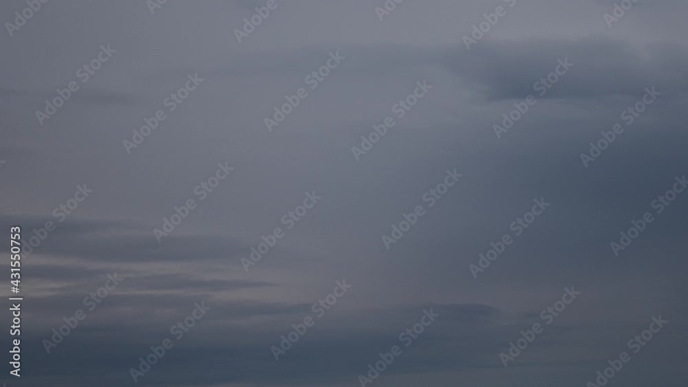 Time lapse overcast sky with grey spindrift clouds while getting dark to night sky. Dramatic sky background. Cloudscape with dark cloud formation from dusk to night darkness Time lapse overcast sky with grey spindrift clouds while getting dark to night sky. Dramatic sky background. Cloudscape with dark cloud formation from dusk to night darkness