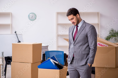 Young male employee in relocation concept