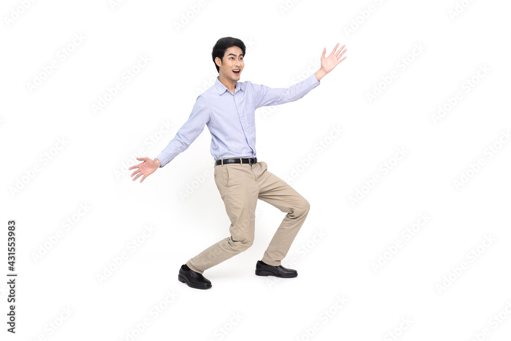 Full length portrait of a cheerful excited Asian businessman standing and presenting with two hands isolated over white background