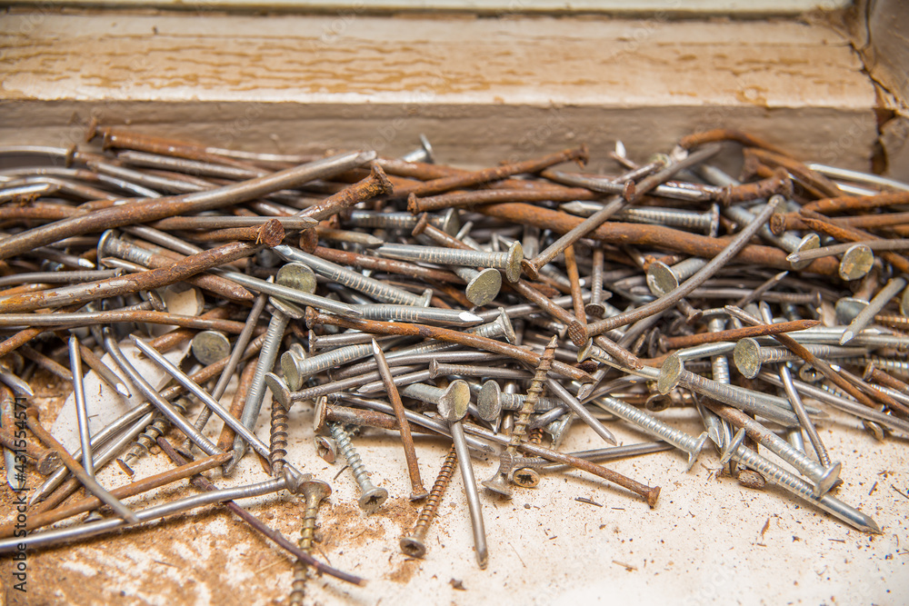Fototapeta premium A bunch of old nails and screws. Rusty nails, scrap metal.