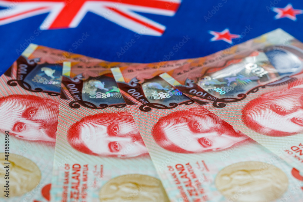 Fototapeta premium New Zealand money on the background of the colors of the national flag, One hundred dollar banknotes, Economic and business concept