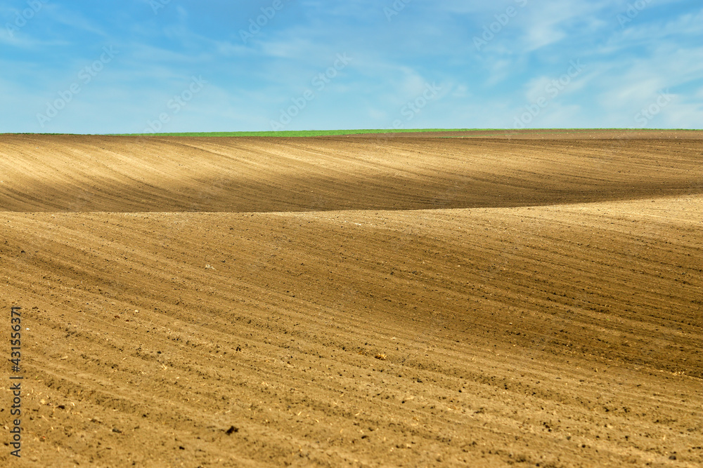 plowed field landscape in springtime agriculture