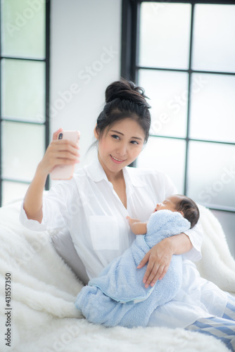 young mother holding child ...