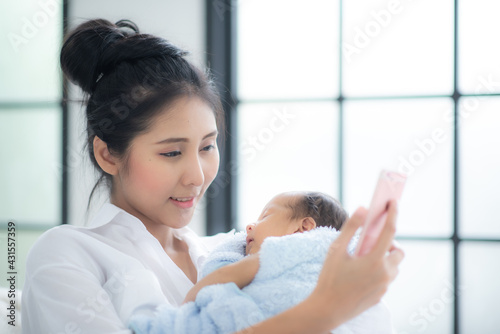 young mother holding child ...