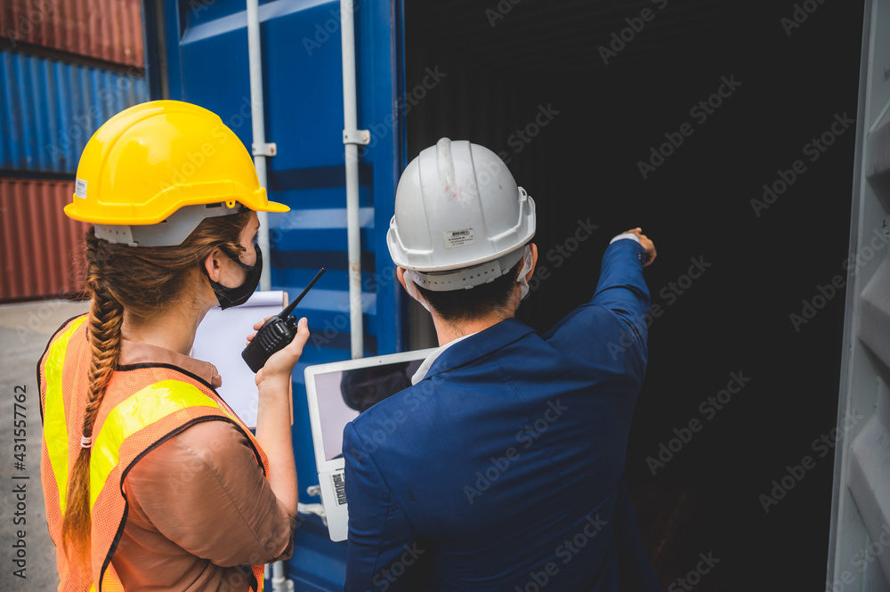 Businessman, executives and engineers wear medical face masks and helmet, While inspecting industrial plants and warehouses for international shipping businesses Concepts of import and export Businessman, executives and engineers wear medical face masks and helmet, While inspecting industrial plants and warehouses for international shipping businesses Concepts of import and export