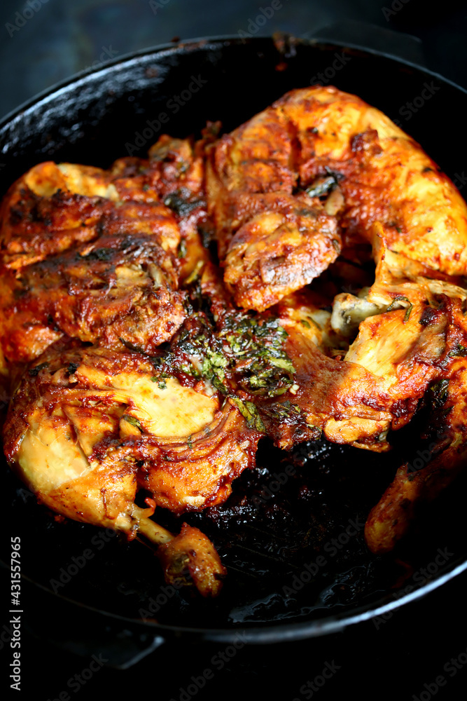 Appetizing grilled chicken in a cast iron pan. Appetizing grilled chicken in a cast iron pan.