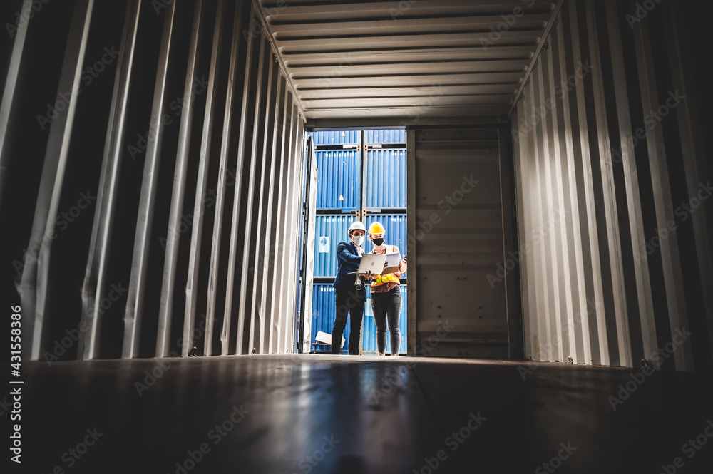Businessmen, executives and engineers wear medical face masks. While inspecting industrial plants and warehouses for international shipping businesses Concepts of import and export. Businessmen, executives and engineers wear medical face masks. While inspecting industrial plants and warehouses for international shipping businesses Concepts of import and export.