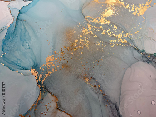 Abstract blue art with gold — fluid background with beautiful smudges and stains made with alcohol ink and golden pigment. Turquoise texture resembles scales, ocean, watercolor or aquarelle.