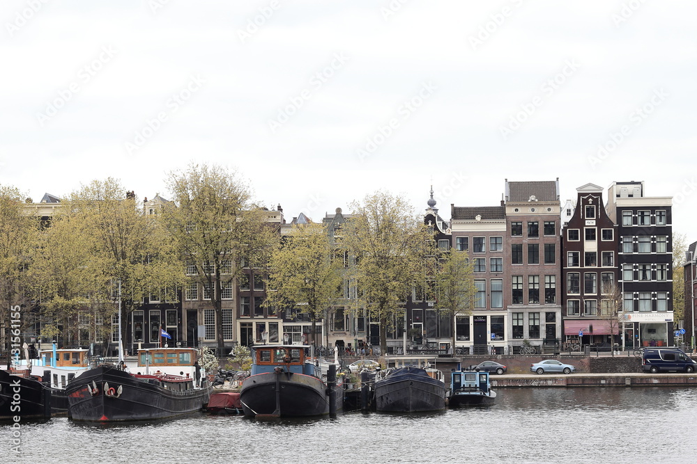 Amsterdam Oosterdok View with Boats, Buildings and Spring Trees