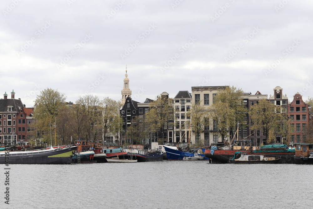 Amsterdam Oosterdok View with Boats, Historical House Facades and White Spire