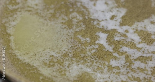 Swirling denatured butter in pan photo