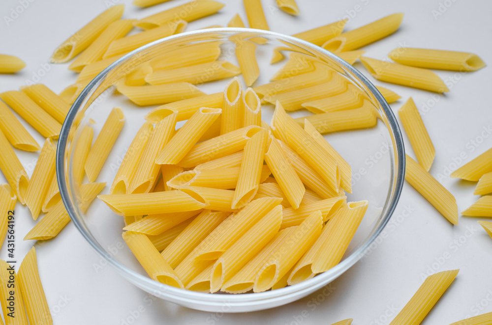 pasta, penne in a clear cup on the table