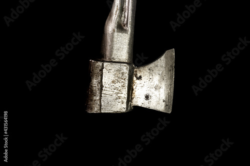 Old silver ax with a metal handle. Isolated on black background