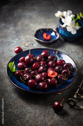 Fresh ripe cherry on blue plate close up