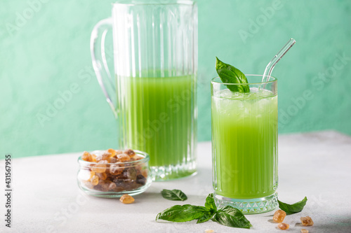 Cold basil lemonade refreshing summer drink on gray background