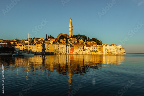 Rovinj,Istria,Croatia.View of the town situated on the coast of Adriatic Sea.Popular tourist resort and fishing port.Old town at sunrise with cobblestone streets, colorful houses and the church tower