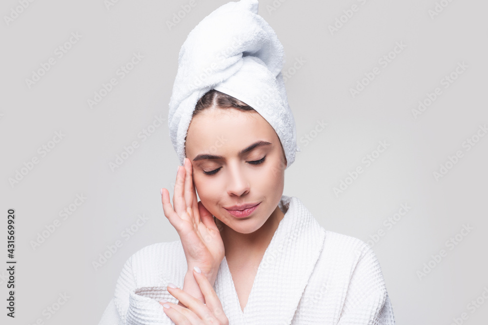 Sensual girl applying moisturizing cream on her face. Photo of young girl with flawless skin. Skincare and beauty concept. Sensual girl applying moisturizing cream on her face. Photo of young girl with flawless skin. Skincare and beauty concept.